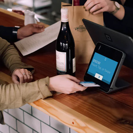 person buying alcohol at a counter